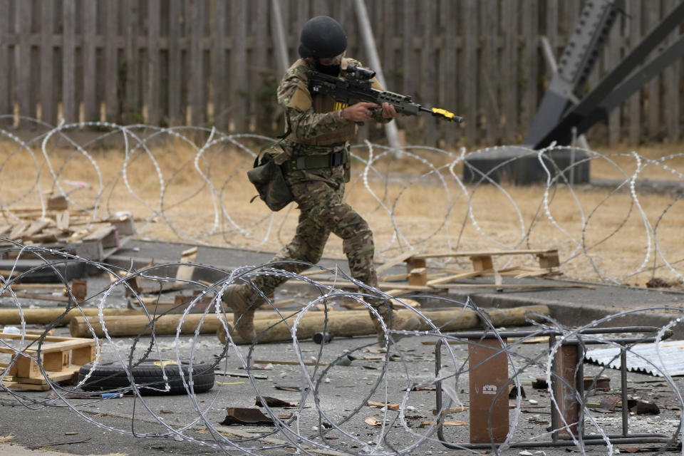 Ukrainian volunteer military recruits take part in an urban battle exercise whilst being trained by British Armed Forces at a military base in Southern England, Monday, Aug. 15, 2022. MOD and British Army as the UK Armed Forces continue to deliver international training of Ukrainian Armed Forces recruits in the United Kingdom.(AP Photo/Frank Augstein)