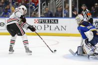 Chicago Blackhawks' Dylan Strome (17) takes a shot on goal as St. Louis Blues goaltender Jordan Binnington (50) defends during the first period of an NHL hockey game Tuesday, Feb. 25 2020, in St. Louis. (AP Photo/Scott Kane)