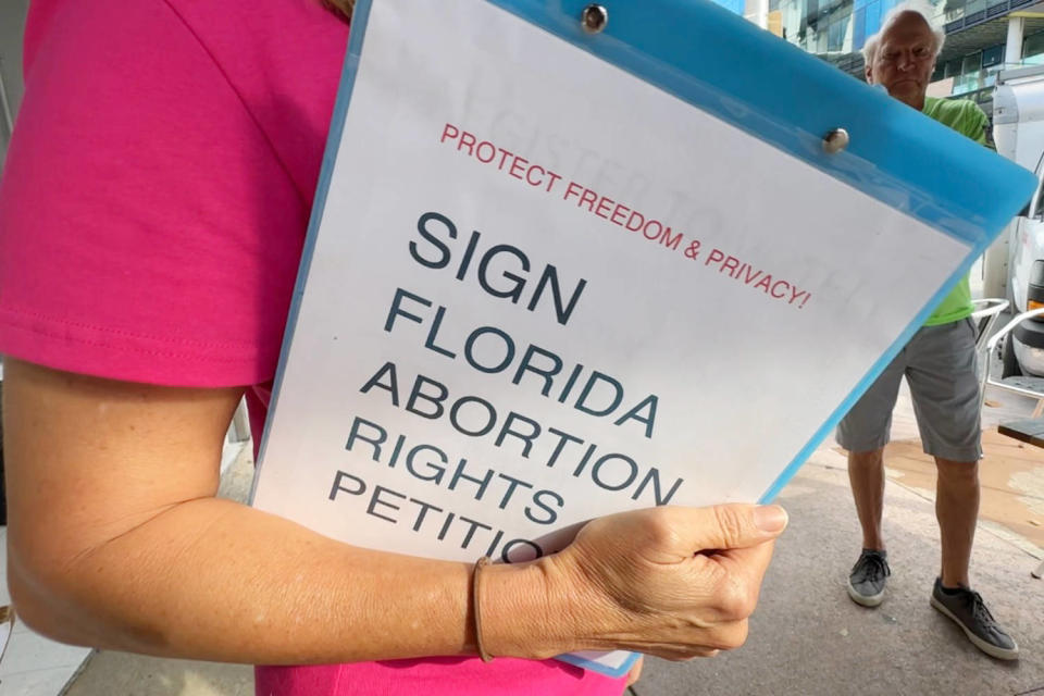 Natalie Kaufman gathers signatures outside a Miami restaurant (Aaron Franco / NBC News)