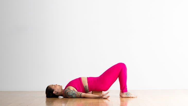 Woman in supported Bridge pose