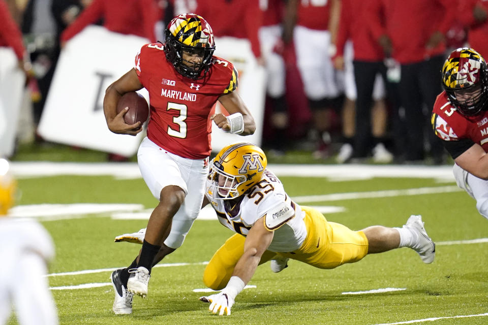 Maryland quarterback Taulia Tagovailoa (3) scrambles for yardage as Minnesota linebacker Mariano Sori-Marin attempts a tackle during the first half of an NCAA college football game, Friday, Oct. 30, 2020, in College Park, Md. (AP Photo/Julio Cortez)