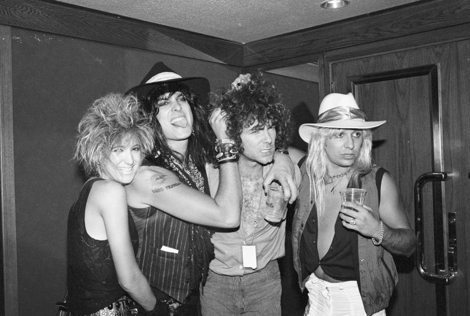 <p>Mötley Crüe members Tommy Lee and Vince Neil pose backstage with friends in 1984, but it wasn't their concert they were attending. The musicians were backstage at a Quiet Riot concert at a venue in Inglewood, California. </p>