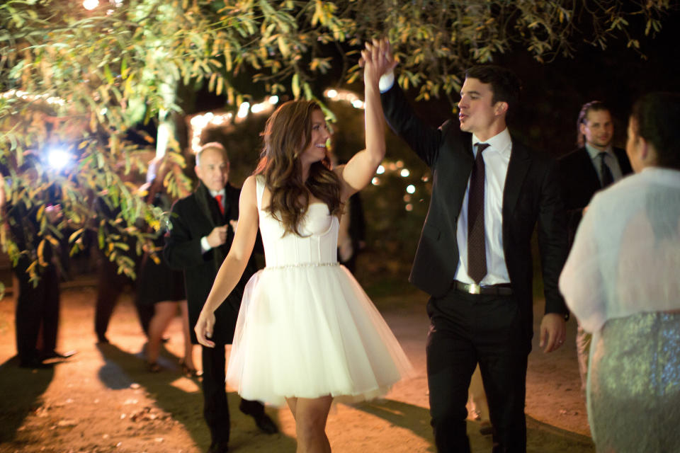 SANTA BARBARA, CA - DECEMBER 31: (EXCLUSIVE COVERAGE) US Soccer stars Alex Morgan and Servando Carrasco celebrate at their wedding reception at Rancho Dos Pueblos on December 31, 2014 in Santa Barbara, California. Morgan's reception dress "Little White Dress," pictured, was custom designed with her input by Amsale.  (Photo by Kamee June Photography/Handout/Getty Images)