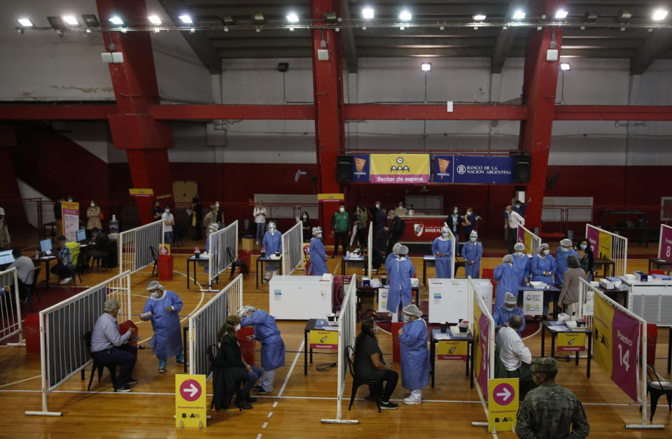 Nurses give health workers shots of Russia's Sputnik V COVID-19 vaccine at River Plate stadium in Buenos Aires, Argentina, Tuesday, Feb. 2, 2021. (AP Photo/Natacha Pisarenko)