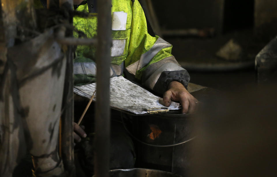 A man works on a 140-meter-long rock-eating machine dubbed "Federica" in a Turin-Lyon high-speed rail tunnel (TAV) in Saint Martin La Porte, France, Tuesday, Feb. 12, 2019. The project is part of a European wide network to improve high-speed rail connections. On the Italian side, the construction site long targeted by sabotaging protesters is guarded by four law enforcement agencies and has been reduced to maintenance work only. The survival of Italy's increasingly uneasy populist government could very well depend on whether Italy restarts construction on the TAV link, which it halted in June. (AP Photo/Antonio Calanni)