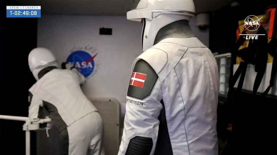 astronauts prepare to enter their spacecraft from the launch tower crew access arm.