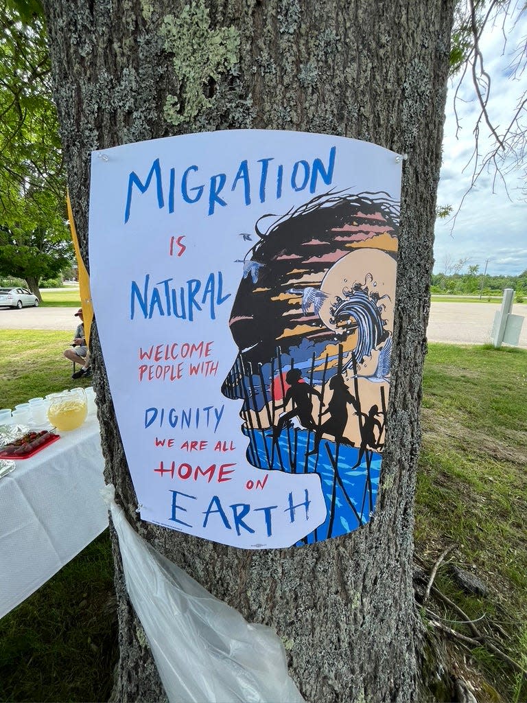 A sign calling to treat immigrants with dignity is seen during a rally outside the Strafford County jail in Dover.