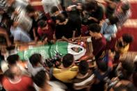 <p>Palestinian mourners surround the body of Yazan al-Tubasi, killed during clashes in Gaza the previous day, during his funeral in Gaza City on May 15, 2018. (Photo: Mahmud Hams/AFP/Getty Images) </p>