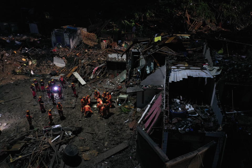 Rescuers search for victims of a landslide triggered by Typhoon Lekima in Yongjia county in eastern China's Zhejiang province on Saturday, Aug. 10, 2019. The official Xinhua News Agency says more than 1 million people were evacuated in coastal Zhejiang province before the typhoon hit land at 1:45 a.m. on Saturday (Chinatopix Via AP)