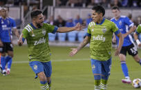 Seattle Sounders forward Raul Ruidiaz, right, celebrates with teammate Cristian Roldan, left, after scoring a goal on a penalty kick against the San Jose Earthquakes during the first half of an MLS soccer match Wednesday, Sept. 29, 2021, in San Jose, Calif.(AP Photo/Tony Avelar)