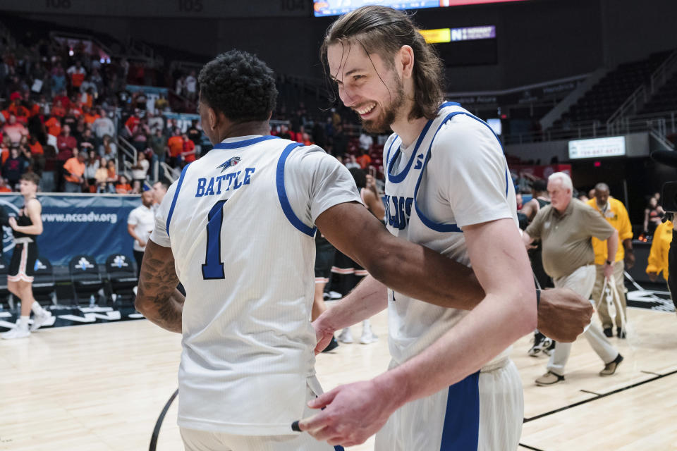 North Carolina Asheville forward Jamon Battle (1) celebrates with forward Drew Pember (4) after defeating Campbell during the Big South Championship NCAA college basketball game on Sunday, March 5, 2023, in Charlotte, N.C. (AP Photo/Jacob Kupferman)