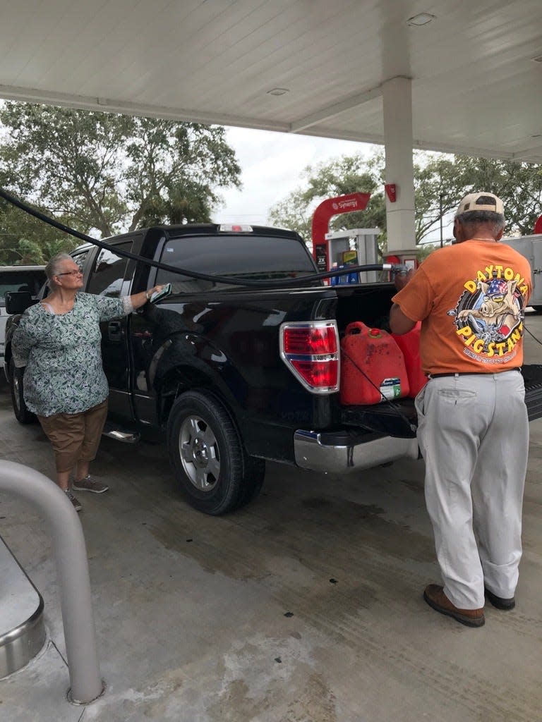 Sue and Jose Morales of Winter Beach fill up gas cans at the 7-11 station on U.S. 1 and County Road 510.