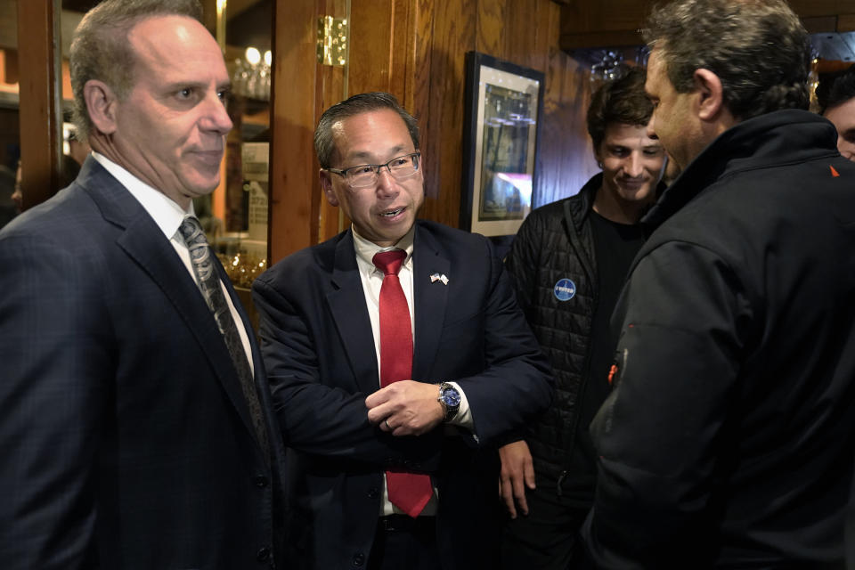 Republican Allan Fung, a former Cranston, R.I., mayor, center, speaks with John Verdecchia, of Johnston, R.I., left, and other supporters, Tuesday, Nov. 8, 2022, in Cranston, after addressing a crowd to concede defeat to Democrat Seth Magaziner in the race for a seat in the U.S. House of Representatives representing the state's 2nd Congressional District. (AP Photo/Steven Senne)