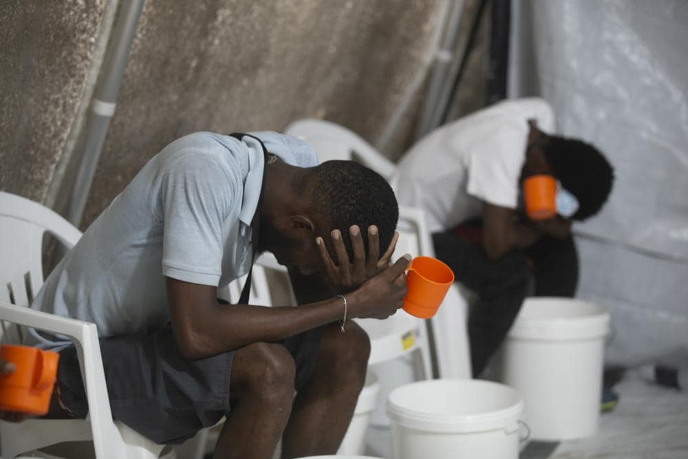 Patients with cholera symptoms sit in an observation center at a cholera clinic run by Doctors Without Borders in Port-au-Prince, Haiti, Friday, Oct. 7, 2022. The World Health Organization and partners are recommending that countries temporarily switch to using a single dose of the cholera vaccine _ instead of two _ due to a global vaccine shortage as outbreaks of the water-borne disease surge globally. (AP Photo/Odelyn Joseph, File)