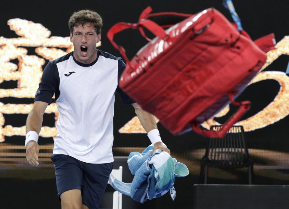 Spain's Pablo Carreno Busta throws his bag in frustration after losing his fourth round match to Japan's Kei Nishikori at the Australian Open tennis championships in Melbourne, Australia, Monday, Jan. 21, 2019. (AP Photo/Aaron Favila)