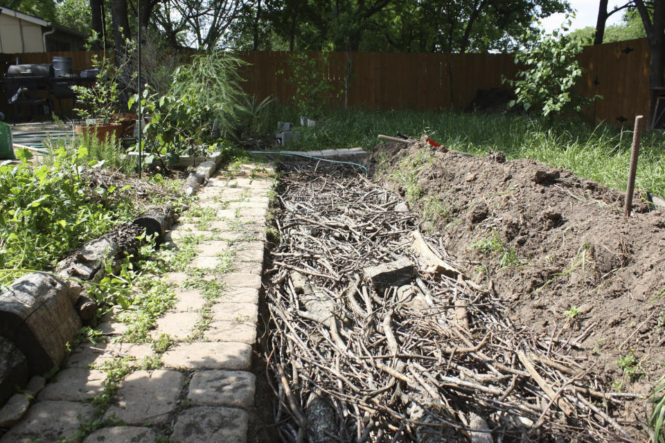 This photo provided by Jon Roberts shows a layer of sticks and branches in a free-standing Hukelkultur bed during its construction. (Jon Roberts/@emptyflask via AP)