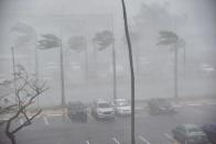 <p>Rain and wind hit a parking lot at Roberto Clemente Coliseum in San Juan, Puerto Rico, on September 20, 2017, during the passage of the Hurricane Maria. (Photo: Hector Retamal/AFP/Getty Images) </p>