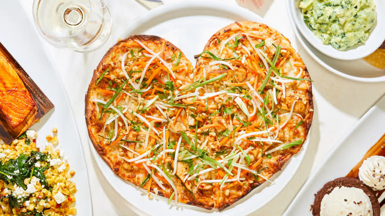 Heart-shaped pizza on plate