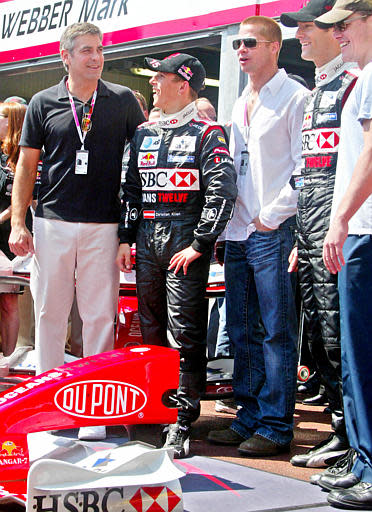 United States actors George Clooney, left, Brad Pitt, third from left, and Matt Damon, right, pose in front of the Jaguar pit with Jaguar Formula One drivers Christian Klien of Austria, second from left, and Mark Webber of Australia during the practice sessions ahead of the Monaco Formula One Grand Prix, Saturday, May 22, 2004. The Monaco Grand Prix takes place Sunday May 23. (AP Photo/Lionel Cironneau)