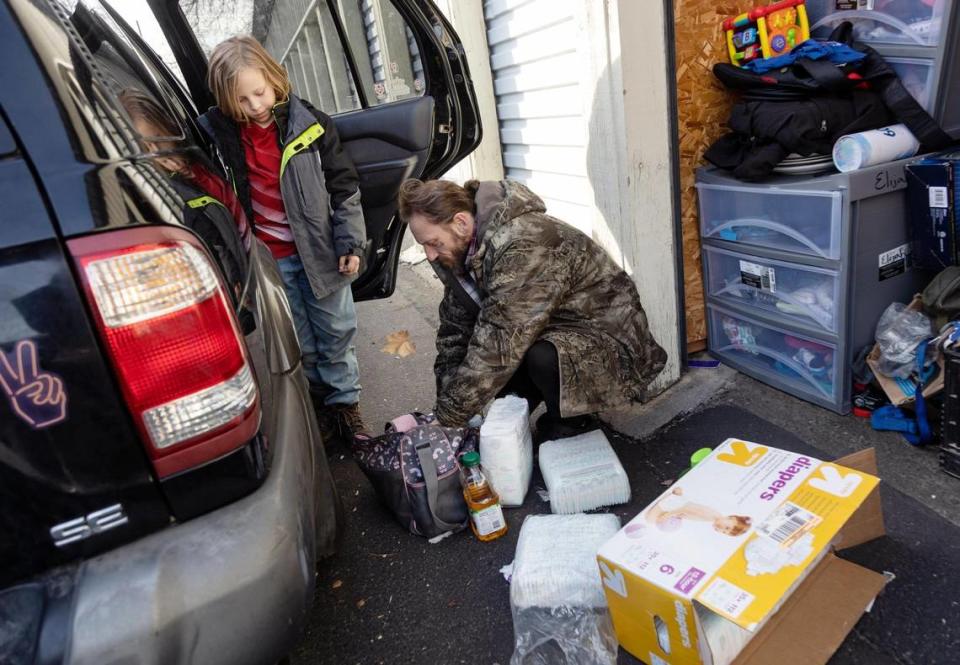 Aiden, 10, and Thomas Lowder visit the family’s storage unit where they keep extra supplies for the two youngest children, such as diapers, snacks and spare sets of clothes.