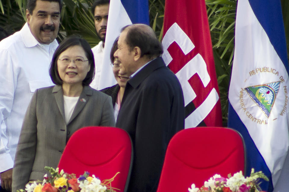 FILE - Nicaragua's President Daniel Ortega, right, welcomes Taiwan's President Tsai Ing-wen, center, at the start of his swearing-in ceremony in Managua, Nicaragua, Tuesday, Jan. 10, 2017. Nicaragua's decision to sever diplomatic links with Taiwan and recognize China leaves the self-governing island democracy with just 14 diplomatic allies. The loss of formal diplomatic allies further constrains the Taiwanese leadership's ability to make state visits abroad and feeds into Beijing's narrative that Taiwan is losing the diplomatic battle and will eventually be forced to accept the inevitable outcome of political union with the People's Republic. (AP Photo/Miguel Alvarez, File)