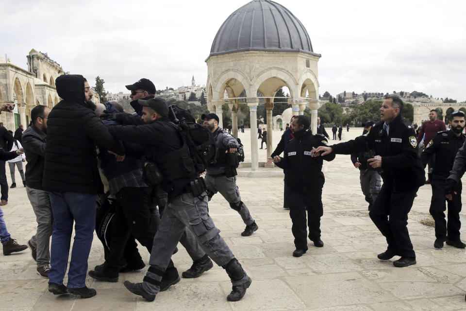 Israeli police confronts Palestinians at al Aqsa mosque compound in Jerusalem, Monday, Feb. 18, 2019. Israeli police officers have arrested several Palestinians for "causing a disturbance" at a flashpoint Jerusalem holy site. The men took part in a prayer protest Monday outside a section of the Temple Mount that has been closed by Israeli court order for over a decade. (AP Photo/Mahmoud Illean)