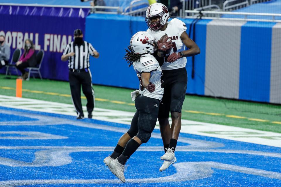 River Rouge Nicholas Marsh (11) celebrates a 2-point conversion against DeWitt with teammate Charles Daniels (26) during the first half of the MHSAA Division 3 final at Ford Field, Saturday, Jan. 23, 2021.