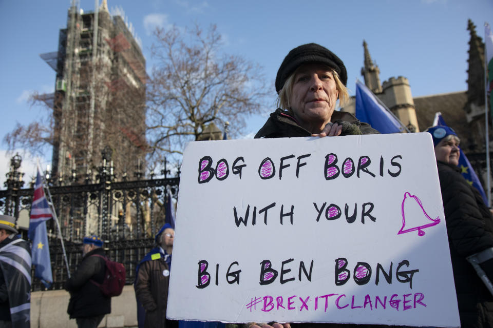 Anti Brexit protester with a placard reading 'Bog off Boris with your Big Ben bong' as a protest of the plan to potentially let Big Ben chime at midnight on 31st January, this protester is ringinga small bell for £5 instead of the £500,000 it is said it will cost to bring the chime back for the 31st at Westminster outside Parliament on 15th January 2020 in London, England, United Kingdom. With a majority Conservative government in power and Brexit day at the end of January looming, the role of these protesters is now to demonstrate in the hope of the softest Brexit deal possible. (photo by Mike Kemp/In Pictures via Getty Images)