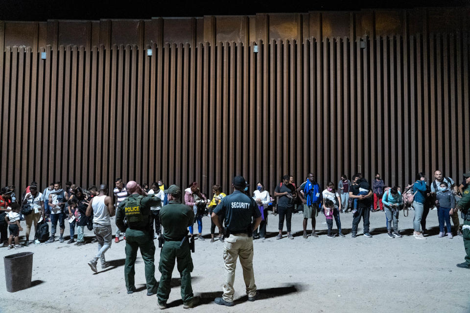 Migrants and asylum seekers are detained by U.S. Border Patrol agents after crossing the U.S.-Mexico border in Yuma County, Arizona, near the Cocopah tribe’s reservation on July 28, 2022.