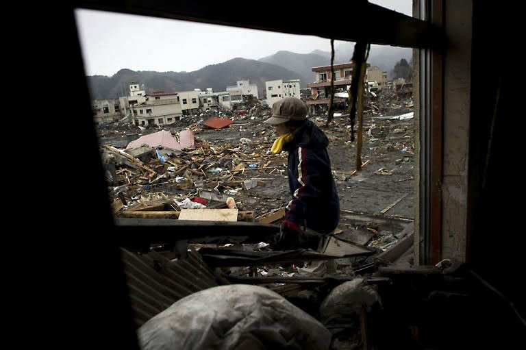 A tsunami survivor clears her house of debris, as she looks for her mother and brother believed to be burried under the debris in the tsunami-damaged town of in Otsuchi, in Iwate prefecture. Radiation levels have surged in seawater near a tsunami-stricken nuclear power station in Japan, officials said Saturday, as engineers battled to stabilise the plant in hazardous conditions