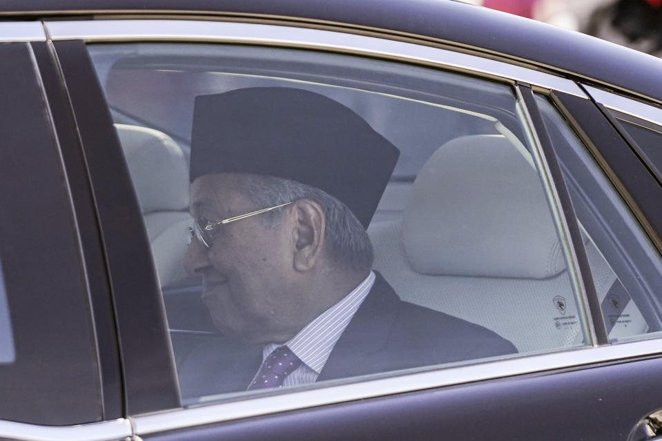 Mahathir Mohamad leaves after meeting with king at National palace in Kuala Lumpur, Malaysia, Thursday, Feb. 27, 2020. Malaysia's king summoned Mahathir to the palace Thursday, fueling talks he may have majority support to return as the next prime minister after his abrupt resignation and the collapse of his ruling coalition this week. (AP Photo/Vincent Thian)