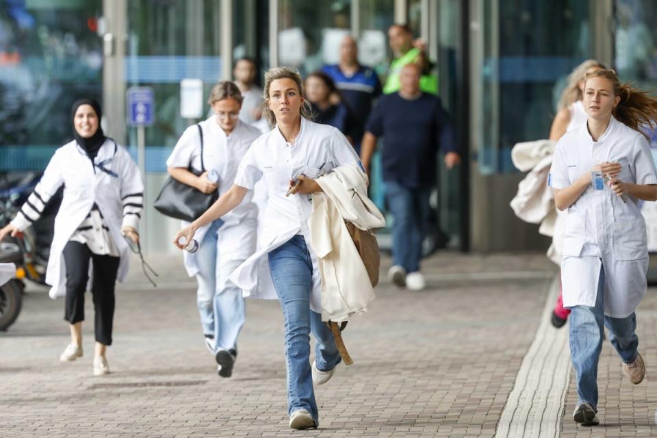 Medical staff leave the Erasmus MC Rotterdam hospital on Rochussenstraat (EPA)