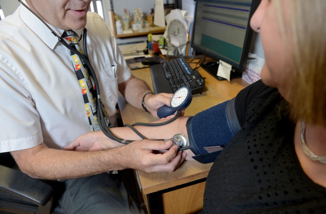 File photo dated 10/09/14 of a doctor checking a patient's blood pressure in his practice room at the Temple Fortune Health Centre GP Practice near Golders Green, London. Doctors will be required to give patients options including travelling further for healthcare or going to private alternatives as Rishi Sunak tries to fulfil his promise to cut NHS waiting times. GPs will be compelled to offer up to five healthcare providers when clinically appropriate, allowing patients to select their preference using the NHS app or website. Issue date: Thursday May 25, 2023.