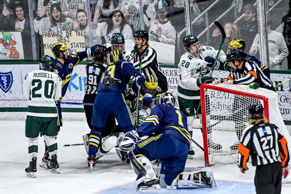 Michigan State and Michigan players get into a scrum during the first period of Friday's game at Munn Arena. The Spartans won that game 2-1 before the Wolverines rebounded to win by the same score on Saturday in Ann Arbor.