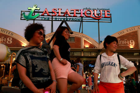 Tourists pose for a photo at Asiatique night market, in Bangkok, Thailand April 23, 2019. REUTERS/Soe Zeya Tun