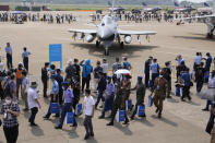 Foreign military officers and other visitors walk past the J-10C fighter jet from the Chinese People's Liberation Army (PLA) Air Force on display during the 13th China International Aviation and Aerospace Exhibition, also known as Airshow China 2021, on Tuesday, Sept. 28, 2021, in Zhuhai in southern China's Guangdong province. (AP Photo/Ng Han Guan)