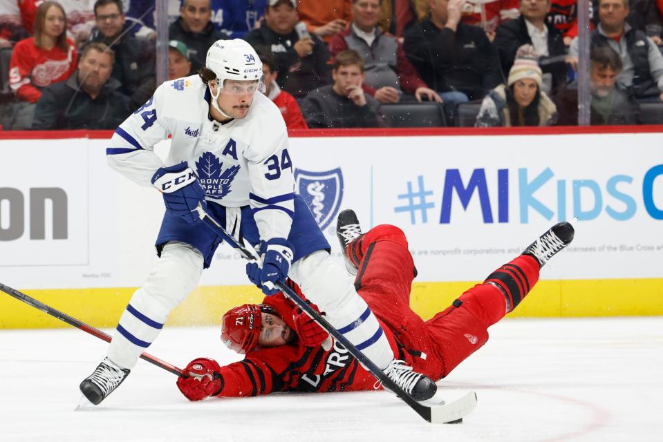 Maple Leafs center Auston Matthews skates with the puck against Red Wings center Dylan Larkin in the first period on Monday, Nov. 28, 2022, at Little Caesars Arena.