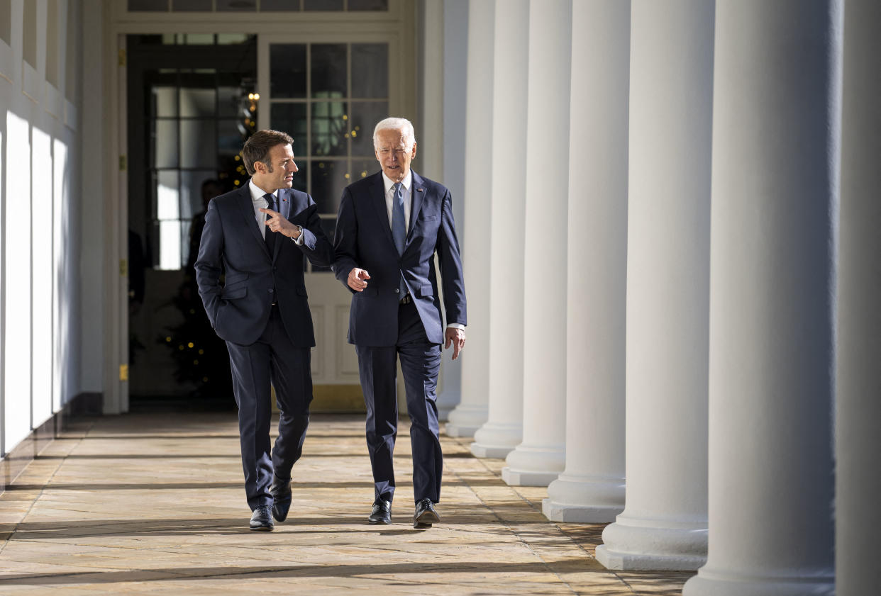 US President Joe Biden (R) and French President Emmanuel Macron walk down the Colonnade at the White House in Washington, DC, on December 1, 2022. (Photo by Doug Mills / POOL / AFP) (Photo by DOUG MILLS/POOL/AFP via Getty Images)