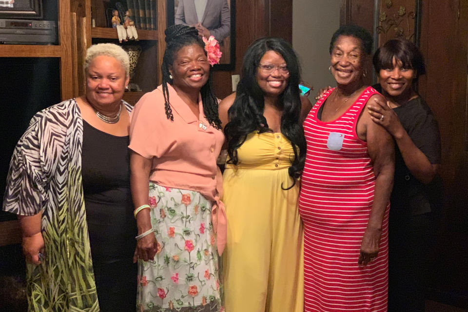 In this photo provided by Steve Morgan, Mary Louise Brown Morgan, second from right, poses with relatives in the fall of 2019. The 78-year-old grandmother died March 27, 2020, after being diagnosed with the new coronavirus. Morgan was described by family members as a “God-fearing woman,” who made a “mean gumbo and red beans,” and loved to tend to her garden of rosebushes and fruit trees. (Steve Morgan via AP)