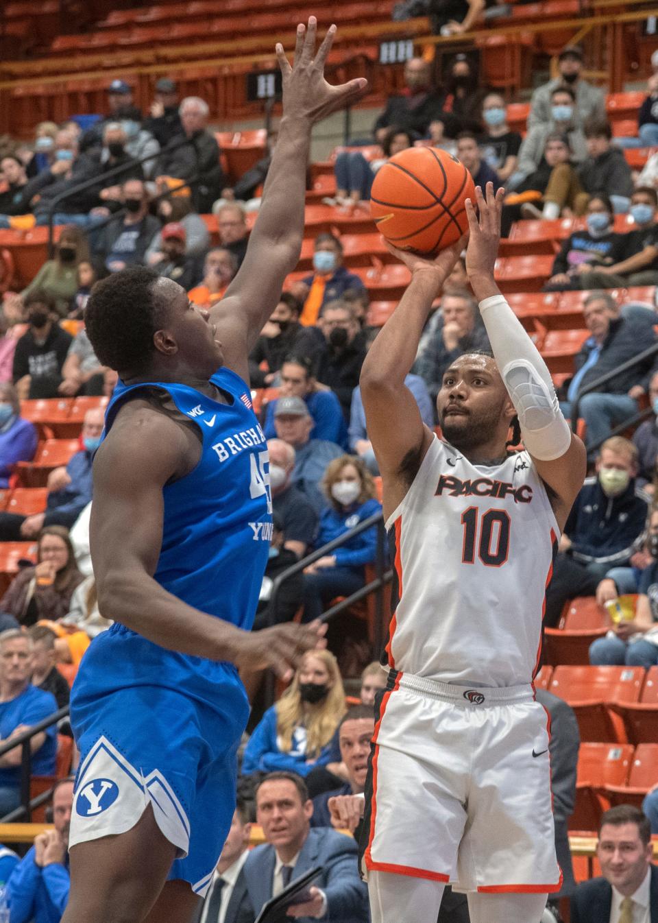 Pacific's Alphonso Anderson, right, shoots over, BYU's Fousseyni Traore during a WCC men's basketball game at UOP's Spanos Center in Stockton.
