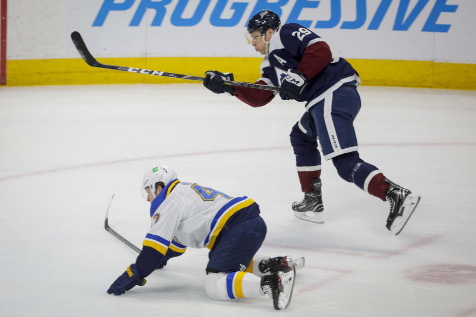 Colorado Avalanche center Nathan MacKinnon (29) scores a goal as St. Louis Blues defenseman Torey Krug (47) falls during the first period of an NHL hockey game in Denver, Saturday, April 3, 2021. (AP Photo/Joe Mahoney)