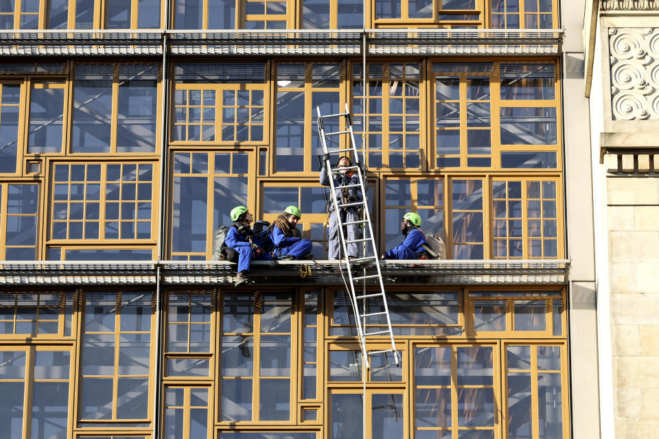 Activists from Greenpeace climb on to the facade of the European Council building, outside of a meeting of EU trade ministers, in Brussels, Thursday, May 25, 2023. The European Union Trade Ministers meet in Brussels Thursday to discuss, among other issues, the state of play of the trade relations with the United States and recent developments in EU-China trade relations. (AP Photo/Geert Vanden Wijngaert)
