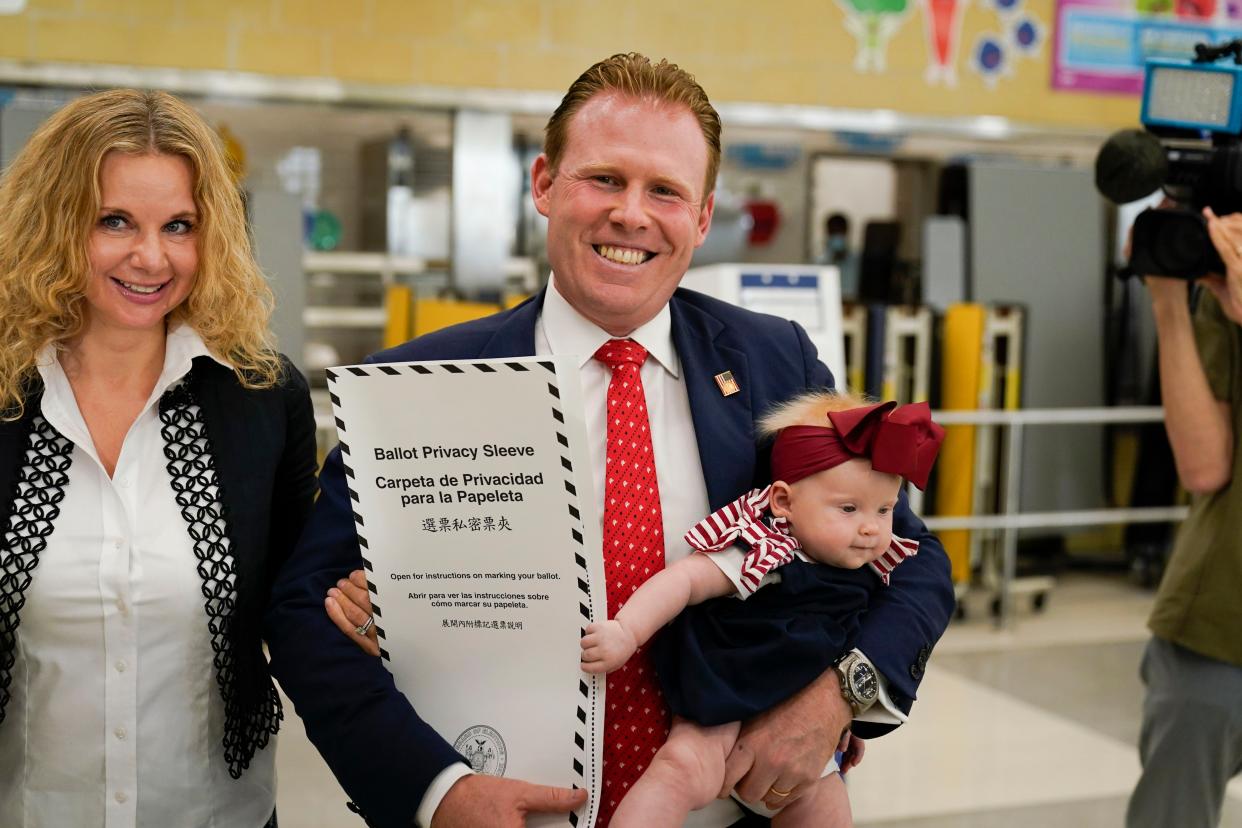 Gubernatorial candidate Andrew Giuliani votes with his wife Zivile Rezgyte and their daughter Grace in New York, Tuesday, June 28, 2022. 