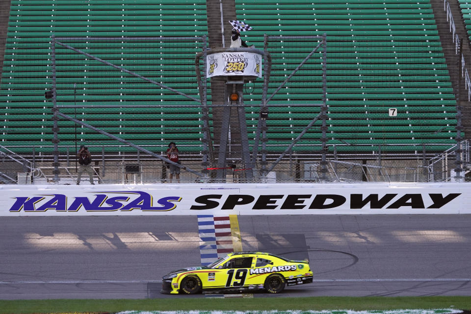 Brandon Jones takes the checkered flag as he wins a NASCAR Xfinity Series auto race at Kansas Speedway in Kansas City, Kan., Saturday, July 25, 2020. (AP Photo/Charlie Riedel)