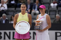 Winner Iga Swiatek, of Poland, right, and second placed Aryna Sabalenka, of Belarus, pose with their awards after the Italian Open tennis tournament final match at Rome's Foro Italico, Saturday, May 18, 2024. Swiatek won 6-2/6-3. (AP Photo/Alessandra Tarantino)