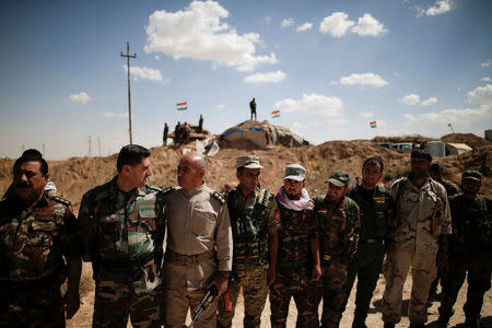 Kurdish Peshmerga fighters line up to welcome Yazidi survivor and United Nations Goodwill Ambassador for the Dignity of Survivors of Human trafficking, Nadia Murad, at a defensive point near Sinjar, Iraq June 1, 2017. REUTERS/Alkis Konstantinidis