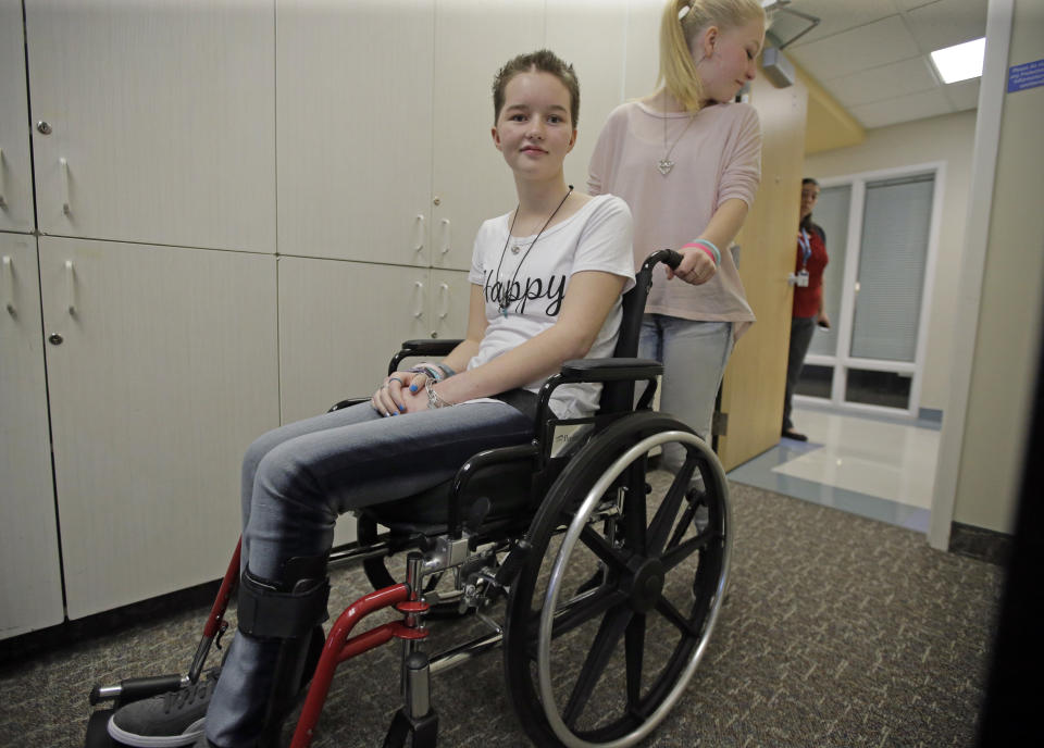 FILE - In this April 20, 2017, file photo, Deserae Turner, a Utah teenage girl who survived being shot in the head by two boys, is wheeled from a news conference after speaking with reporters at Primary Children's Hospital in Salt Lake City. Turner, a Utah high school student who survived a gunshot wound to the head was named homecoming queen by her classmates. Turner was found in a ditch after being shot in the back of the head and left for dead by two classmates in February 2017. (AP Photo/Rick Bowmer, File)