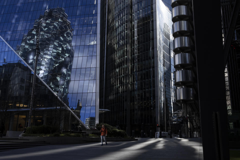 LONDON, ENGLAND - MARCH 19: A sole member of the public walks near the Lloyds of London building at what would be rush hour on March 19, 2021 in London, England. A year since the British government issued its first stay-at-home order in response to the Covid-19 pandemic, on March 23, 2020, the City of London is still a ghost town of shuttered shops and restaurants, scarcely populated offices, and negligible tourist traffic. Even as the UK prepares to ease the current lockdown measures, a sense of normality in the city's historic financial district feels a long way off. (Photo by Dan Kitwood/Getty Images)