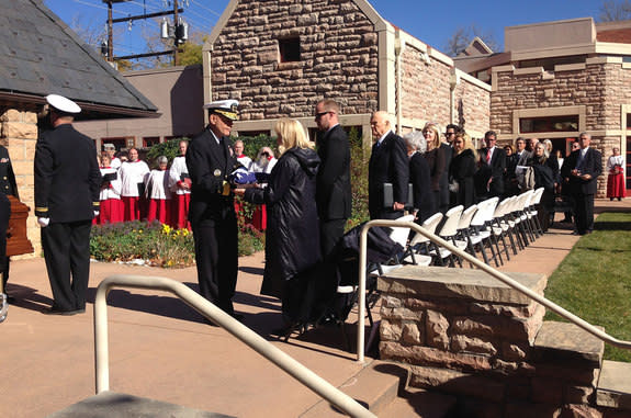 The American flag that draped astronaut Scott Carpenter's casket is presented to his widow at the conclusion of the Saturday (Nov. 2) funeral service in Boulder, Colo. Looking on are family members and fellow Mercury astronaut John Glenn (fourt