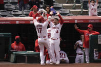 Los Angeles Angels' Shohei Ohtani, left, of Japan, celebrates his home run with Jose Iglesias during the third inning of a baseball game against the Texas Rangers, Wednesday, April 21, 2021, in Anaheim, Calif. (AP Photo/Jae C. Hong)